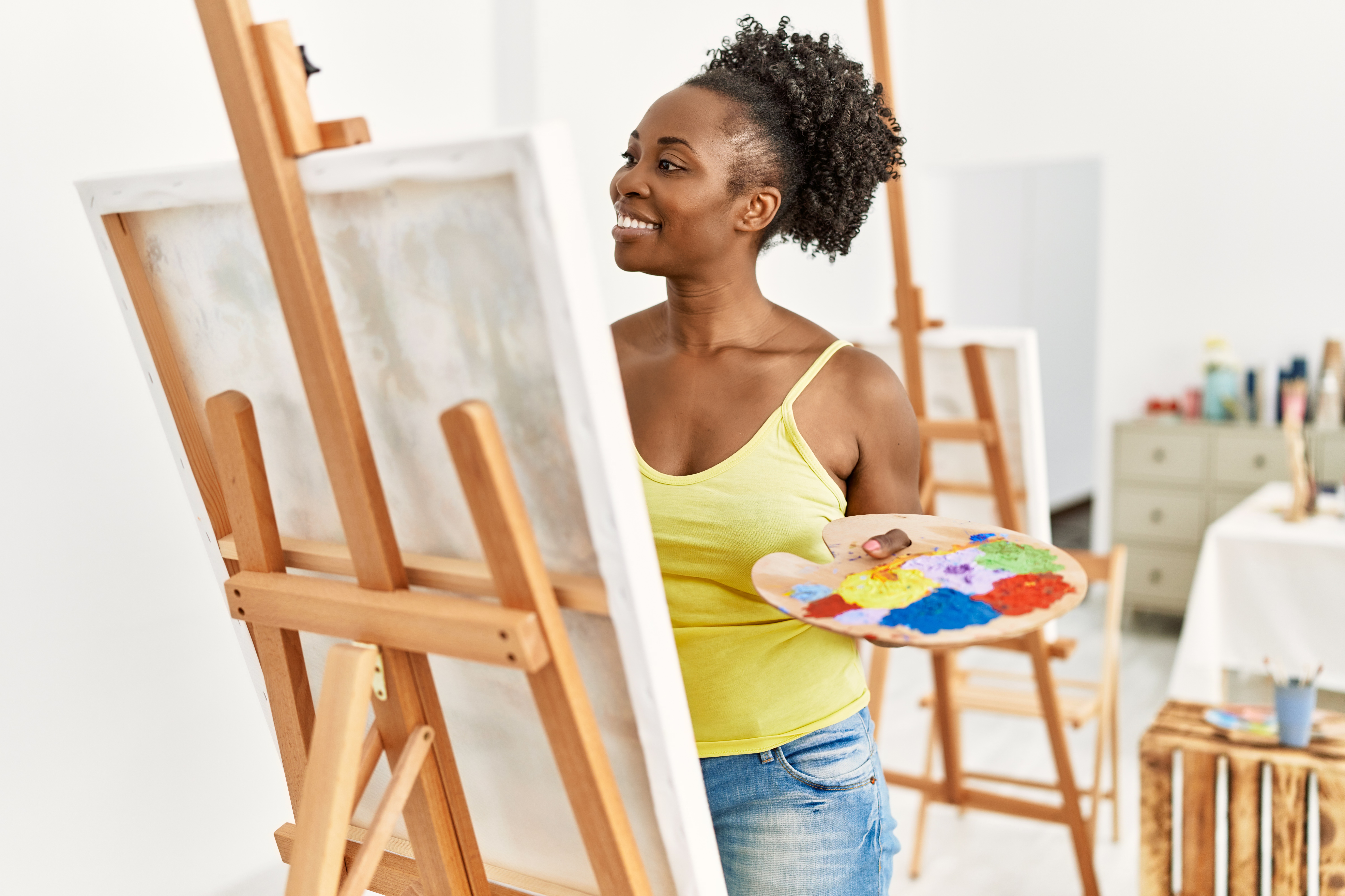 Young african american artist woman smiling happy drawing at art studio.