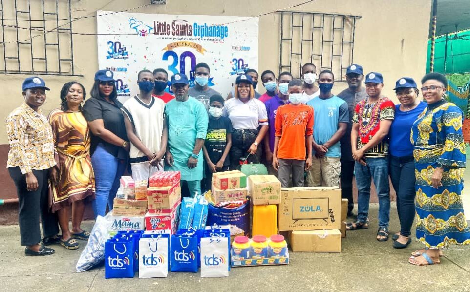 CAPTIONProcurement Executive, Ronke Sogbamu (left); Head HR, Titilope Olatunji (third left); Technical Team Lead, Taofeek Bakare (fifth left); Brand Manager, Rachael Edache (seventh left); Sales Manager Amaka Umejei, (second right); Technical Team Lead, Francis Daniel (third right); and Head Accountant, Victor Okolo (fourth right) with some residents of Little Saints Orphanage during the visit