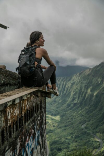 A woman sitting near a cliff