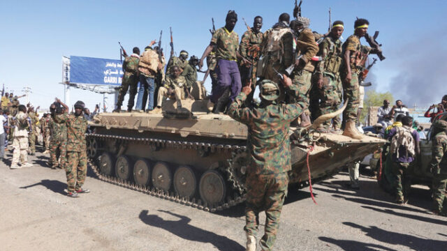 Sudan’s army soldiers celebrate the army’s liberation of an oil refinery, in North Bahri, Sudan