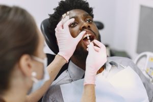 African patient in dentistry sitting in dental chair