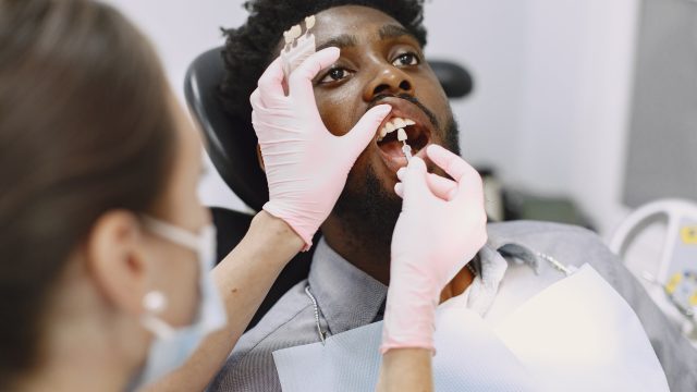 African patient in dentistry sitting in dental chair