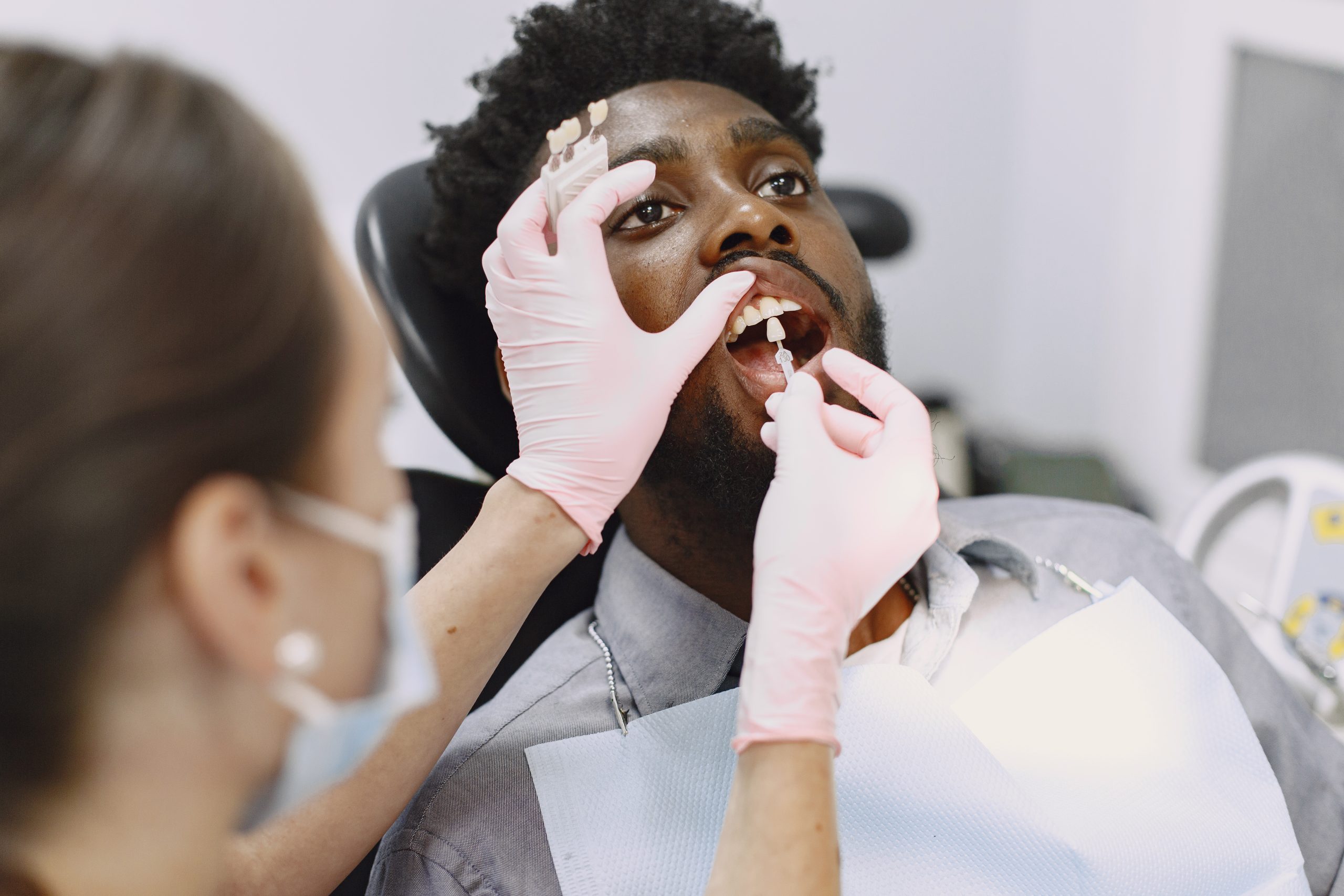 African patient in dentistry sitting in dental chair