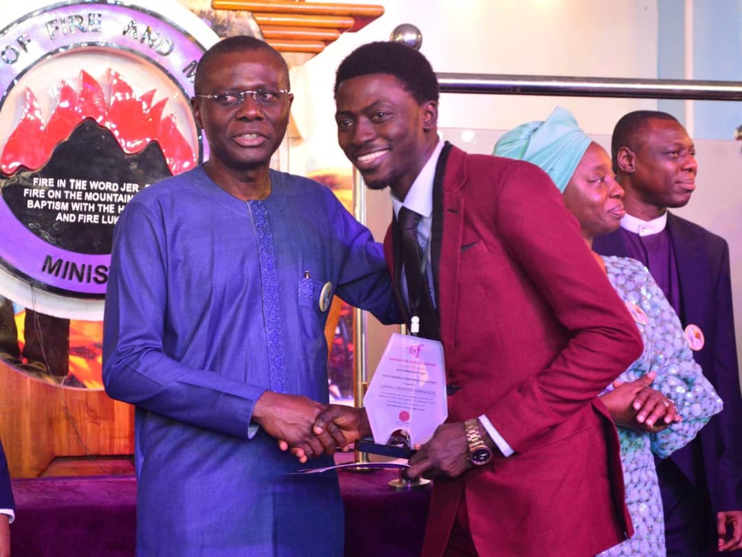 Lagos State Governor, Babajide Sanwo-olu, presenting an award of excellence to Charles Lawal at a formal ceremony attended by dignitaries, educators, and industry leaders.