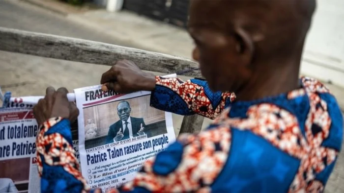 A man flipped through the dailies aftermath Sunday’s foiled coupd’etat in Benin Republic. Photo AFP