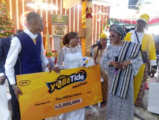 Chief Marketing Officer of MTN Nigeria presenting the money to the couple