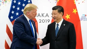 China’s President Xi Jinping (R) shaking hands with US President Donald Trump before a bilateral meeting on the sidelines of the G20 Summit in Osaka. With his storm of tariffs on Chinese goods, US President Donald Trump on April 2025 has torched ties with Beijing and likely wrecked any hope of meeting his counterpart Xi Jinping in the near term, analysts say. (Photo by Brendan Smialowski / AFP) / TO GO WITH AFP STORY CHINA-US-DIPLOMACY-POLITICS-TRADE-ECONOMY,ANALYSIS BY MATTHEW WALSH