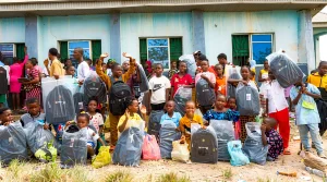 Group photo of children with their gifts as community members gathered at Segilola Resources Christmas celebration in Osun State.