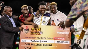 Ijomini “Smiling Assassin” (middle) displaying his Mojisola Ogunsanya Memorial Trophy as the best boxer at the GOtv Boxing Night 34 at the weekend.