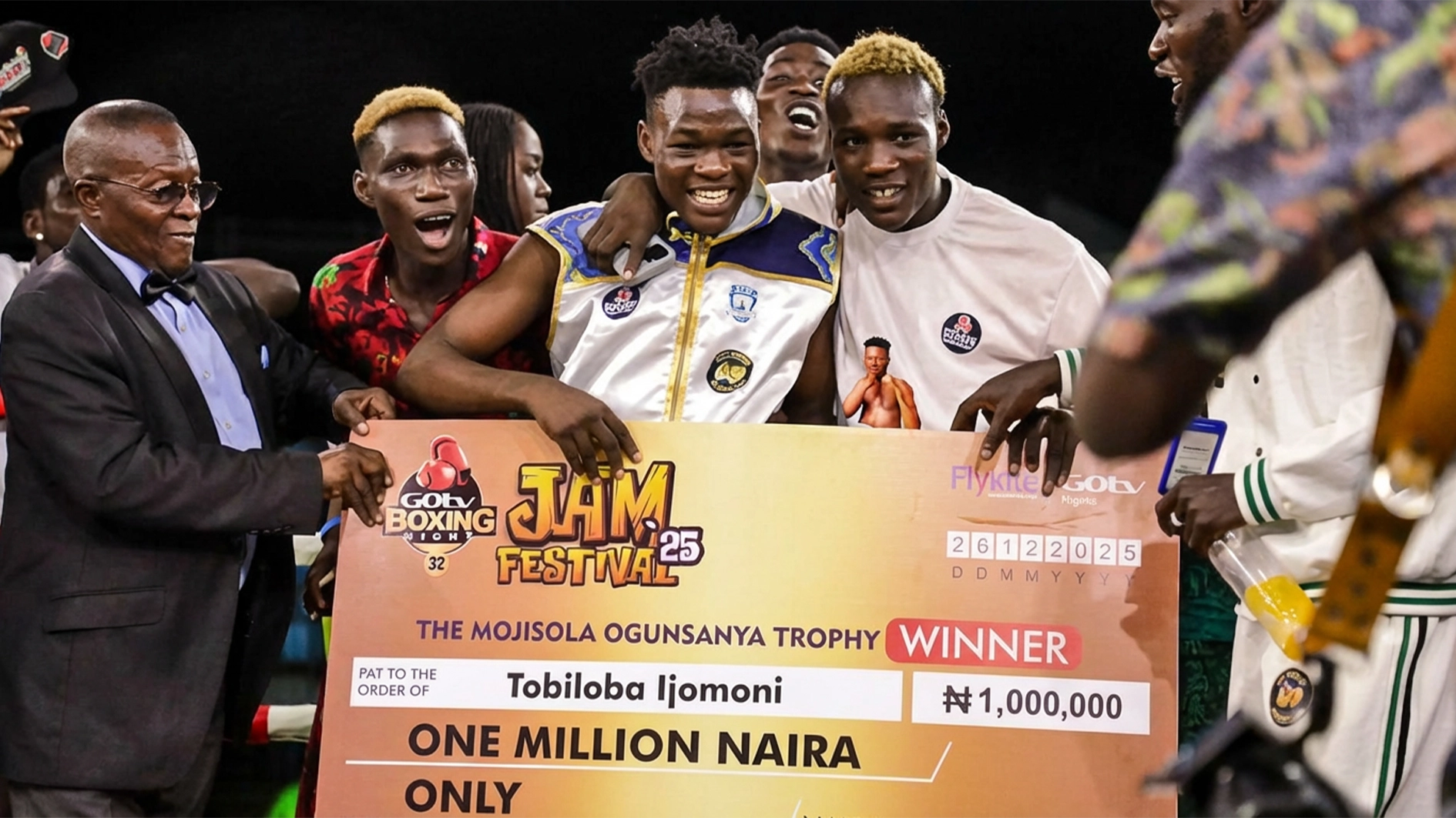 Ijomini “Smiling Assassin” (middle) displaying his Mojisola Ogunsanya Memorial Trophy as the best boxer at the GOtv Boxing Night 34 at the weekend.
