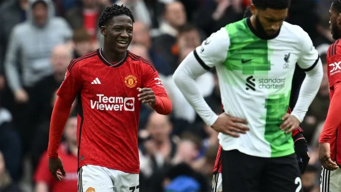 Manchester United’s English midfielder #37 Kobbie Mainoo (L) celebrates after scoring their second goal during the English Premier League football match between Manchester United and Liverpool at Old Trafford in Manchester, north west England, on April 7, 2024. (Photo by Paul ELLIS / AFP) / RESTRICTED TO EDITORIAL USE. NO USE WITH UNAUTHORIZED AUDIO, VIDEO, DATA, FIXTURE LISTS, CLUB/LEAGUE LOGOS OR ‘LIVE’ SERVICES. ONLINE IN-MATCH USE LIMITED TO 120 IMAGES. AN ADDITIONAL 40 IMAGES MAY BE USED IN EXTRA TIME. NO VIDEO EMULATION. SOCIAL MEDIA IN-MATCH USE LIMITED TO 120 IMAGES. AN ADDITIONAL 40 IMAGES MAY BE USED IN EXTRA TIME. NO USE IN BETTING PUBLICATIONS, GAMES OR SINGLE CLUB/LEAGUE/PLAYER PUBLICATIONS. – RESTRICTED TO EDITORIAL USE. No use with unauthorized audio, video, data, fixture lists, club/league logos or ‘live’ services. Online in-match use limited to 120 images. An additional 40 images may be used in extra time. No video emulation. Social media in-match use limited to 120 images. An additional 40 images may be used in extra time. No use in betting publications, games or single club/league/player publications. /