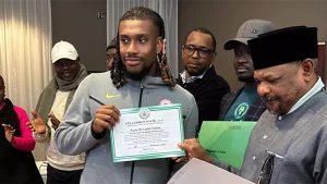 Super Eagles midfielder, Alex Iwobi displayes his land and house certicate