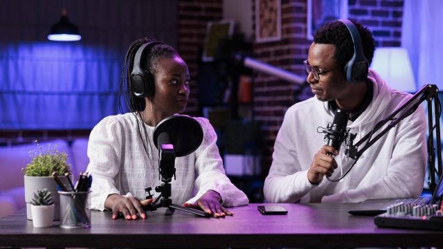 POV of man and woman recording live discussion on camera