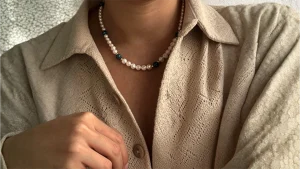 A person adorned with a beaded necklace