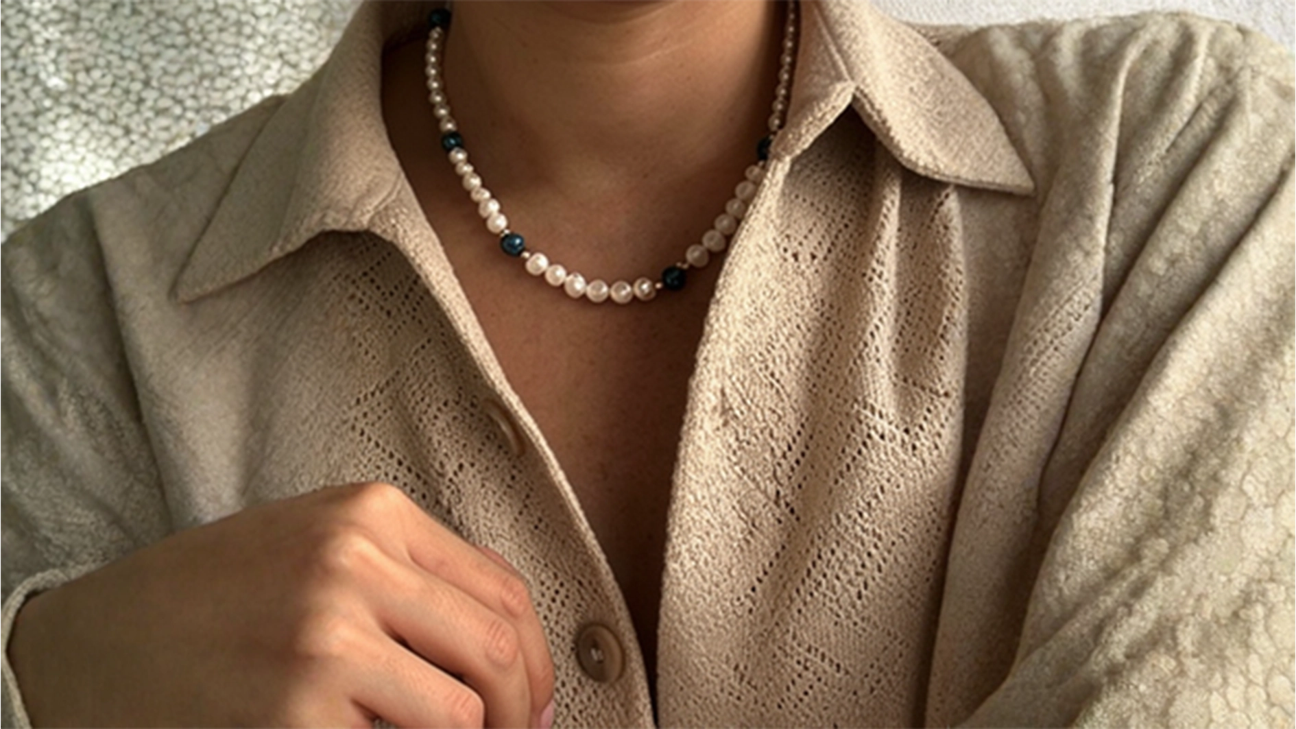 A person adorned with a beaded necklace