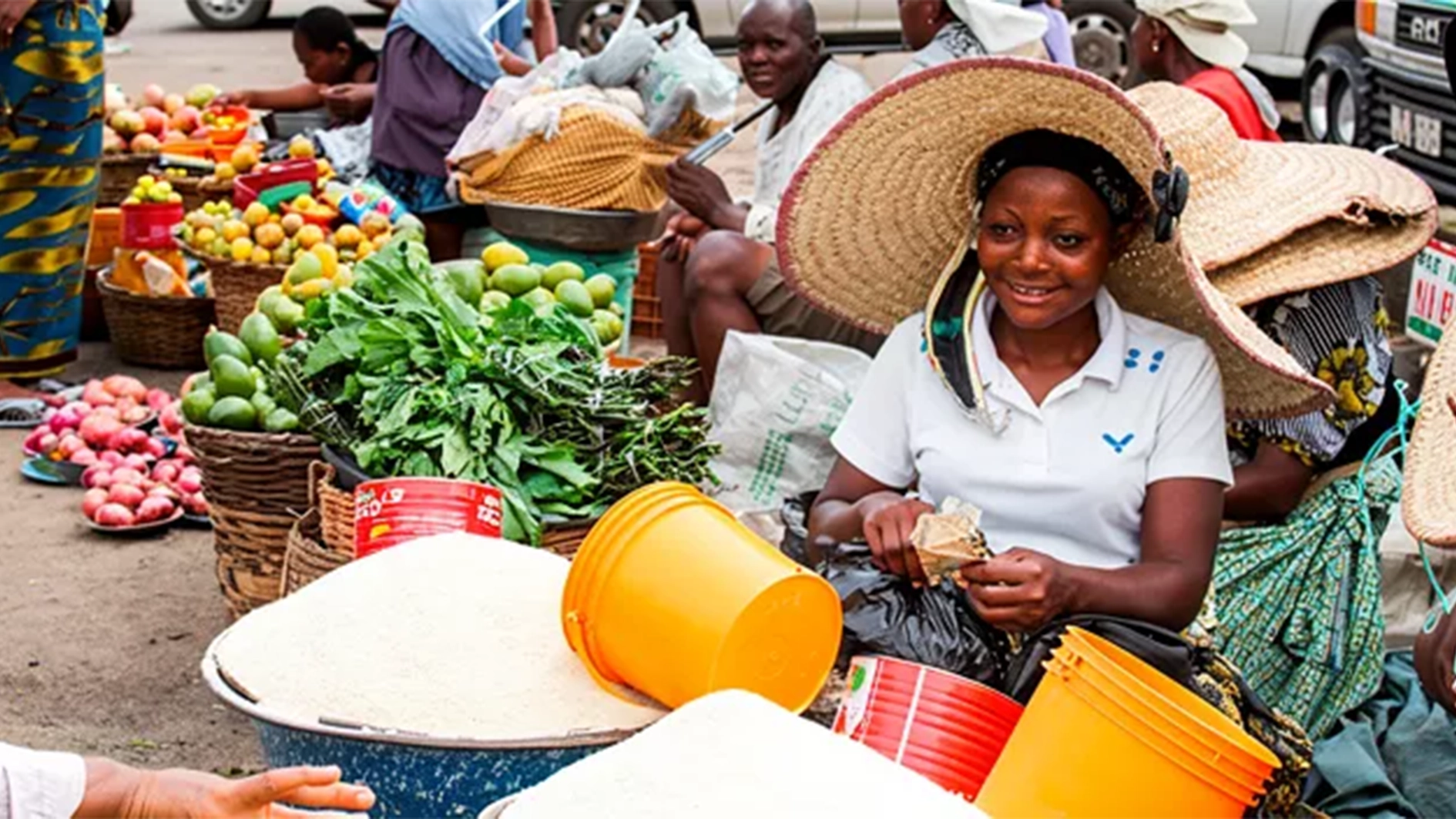 A woman receives money from a customer inside Mile 12 Food Market in Lagos.