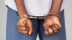 Arrested man handcuffed hands at the back.