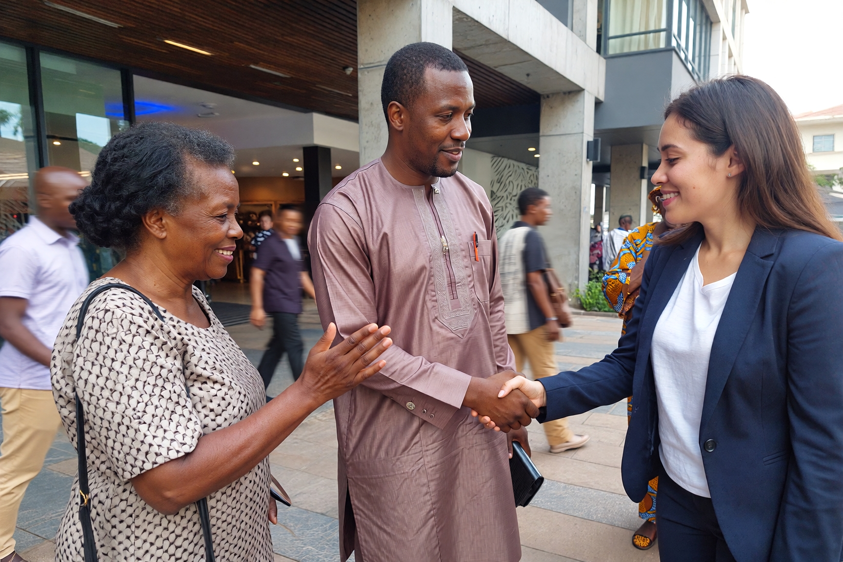 Young Nigerian man shaking hands with a young american woman