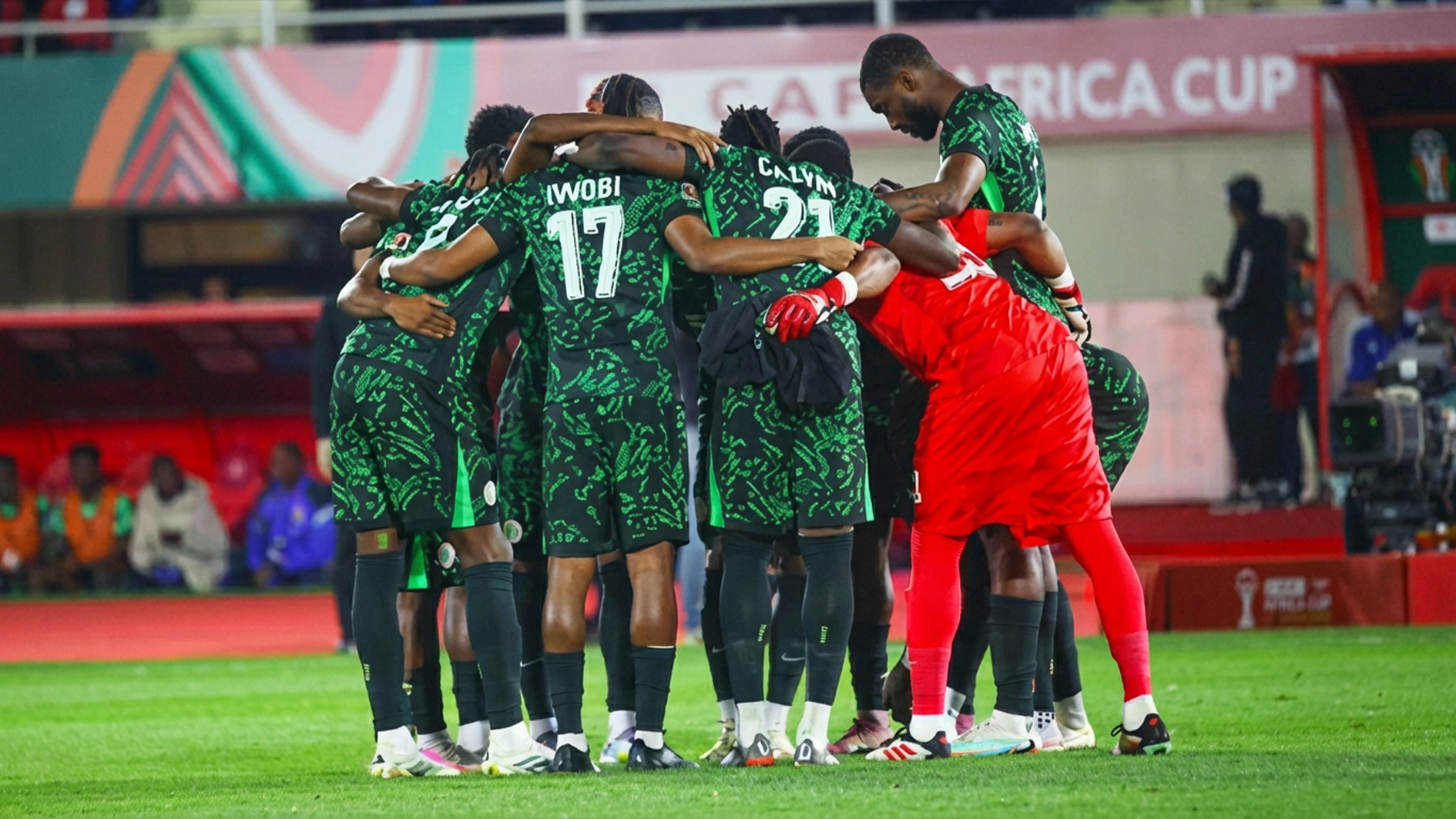 Super Eagles players come together in a huddle before their AFCON 2025 match against Tanzania.