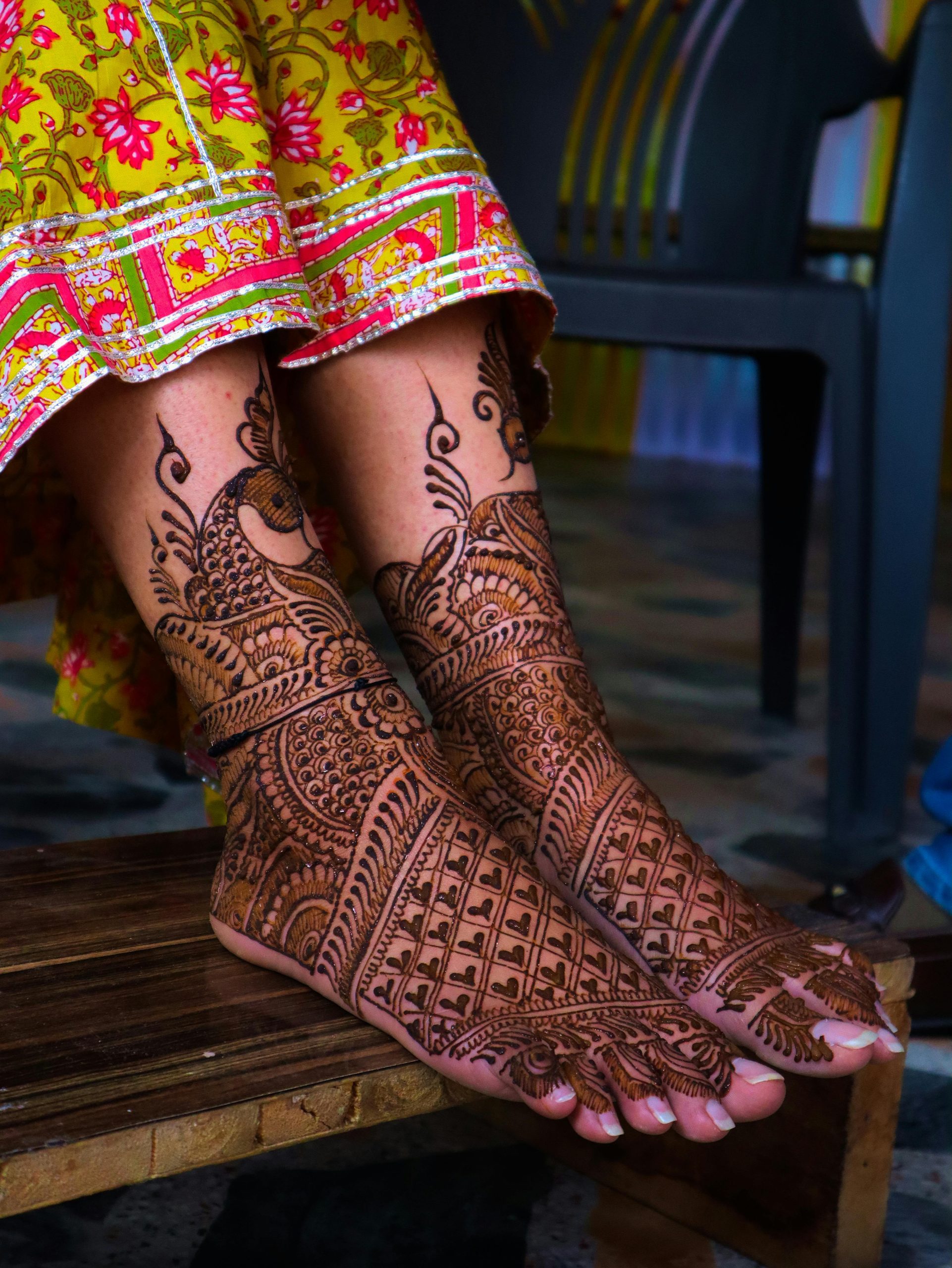 Red-coloured leg henna design 