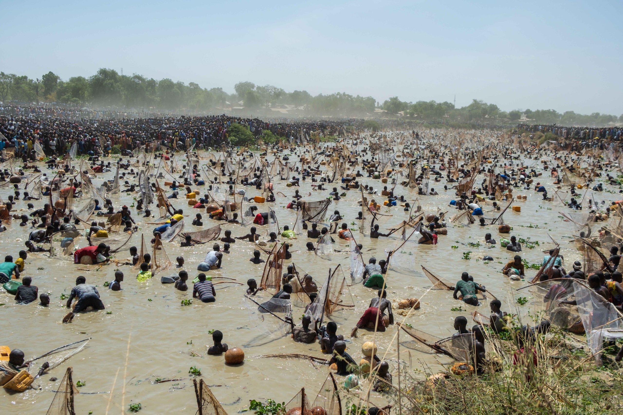 Fishermen attempt to catch fish in the Mata Fada river during the Argungu Fishing and Cultural Festival in Argungu Town, Kebbi State in northwest Nigeria, on February 14, 2026. (Photo by TOYIN ADEDOKUN / AFP)
