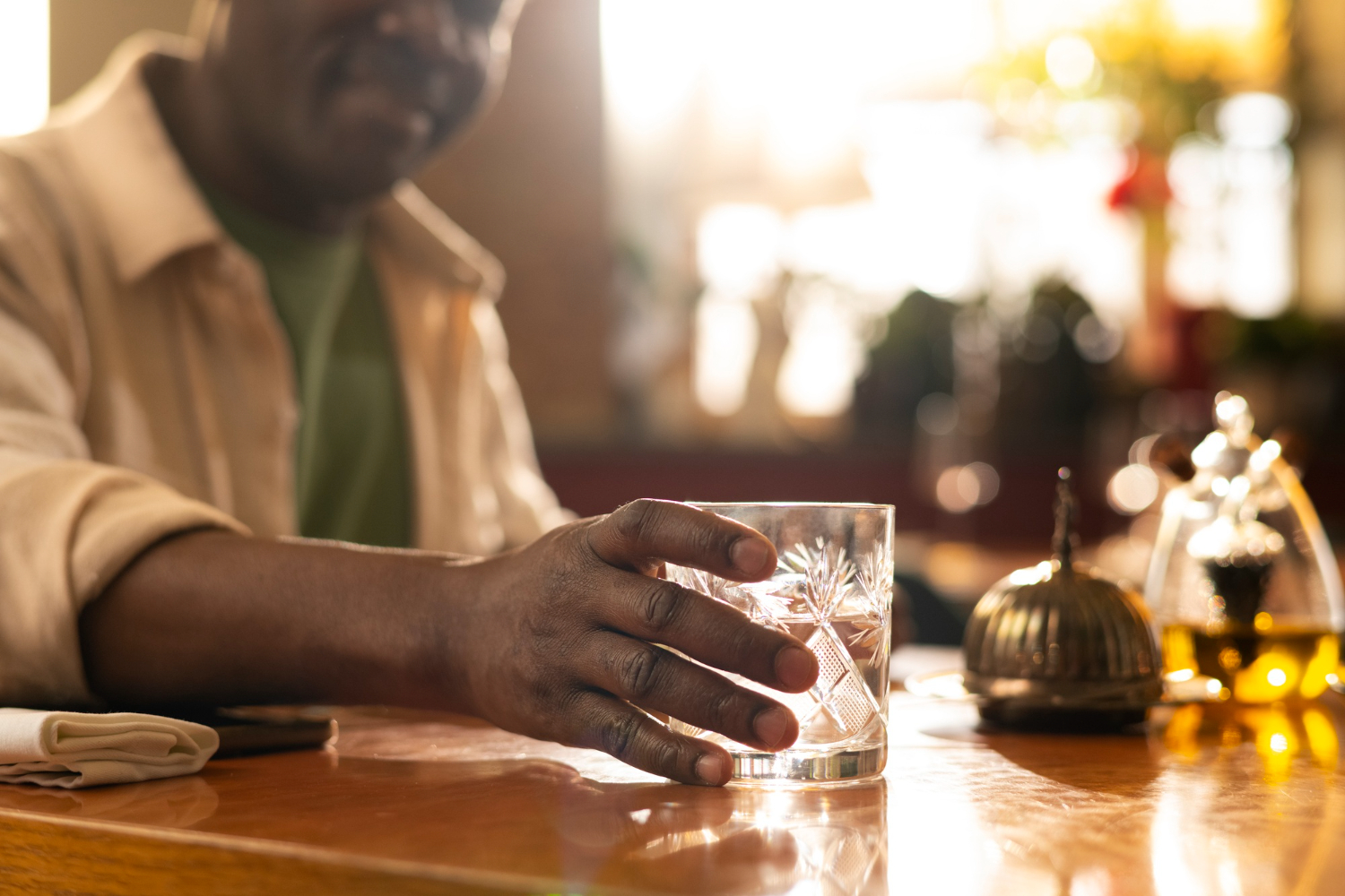 A man holding a glass cup of water