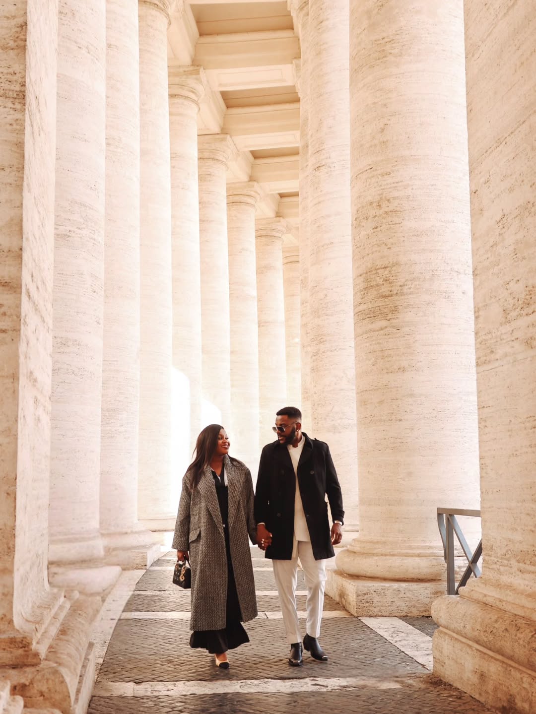 Ebuka Obi-Uchendu and wife Cynthia walking hand in hand at the Vatican during their 10th wedding anniversary celebration