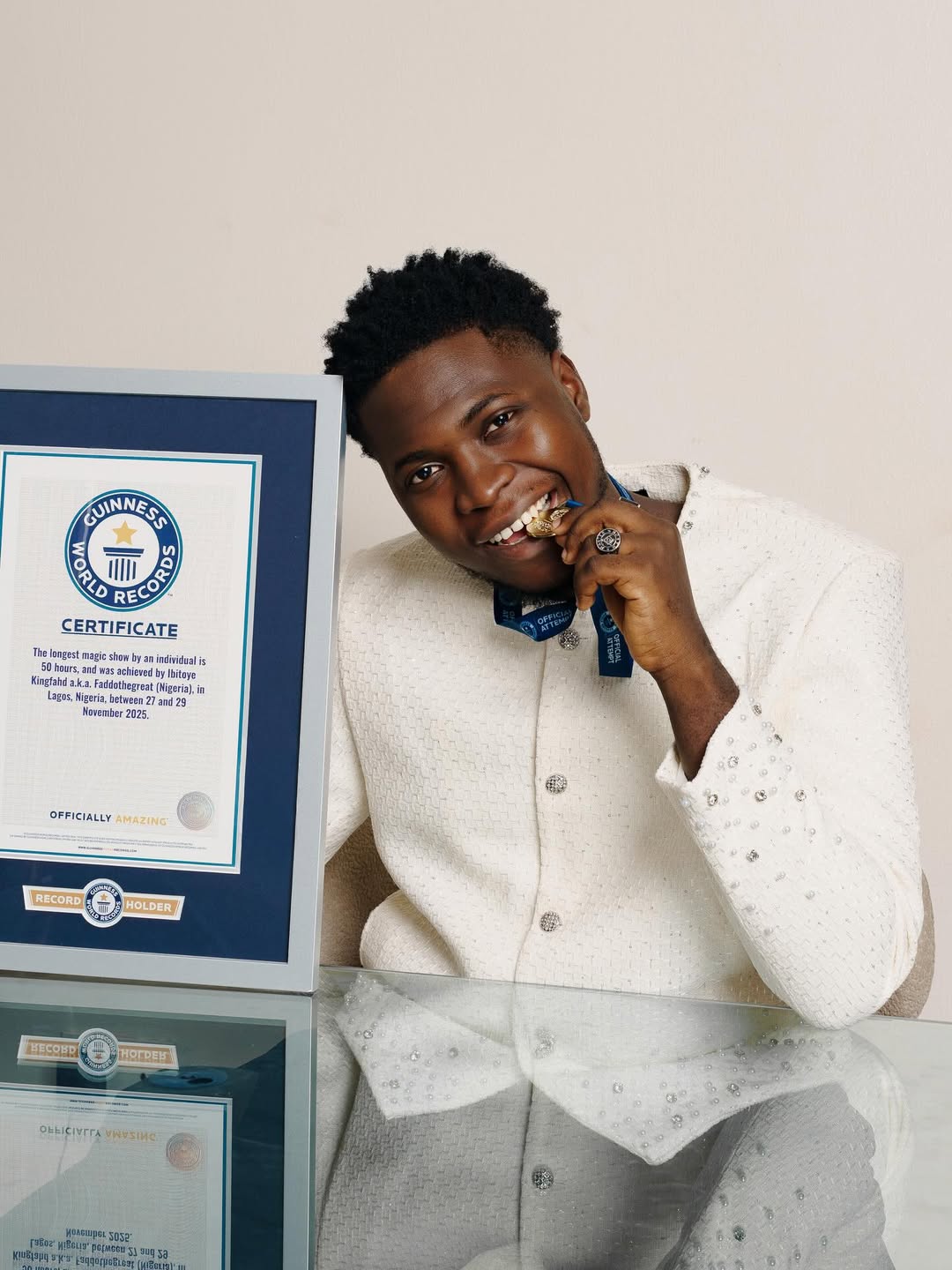Nigerian magician FaddotheGreat, Ibitoye Kingfahd, holds his Guinness World Records certificate for longest magic show.
