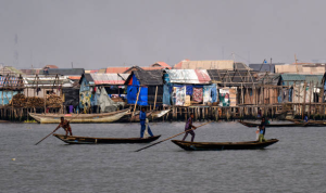 Fishing boats sail on the water in front of the Makoko settlement. Around 200,000 people live in the stilt settlement in the Lagos lagoon.