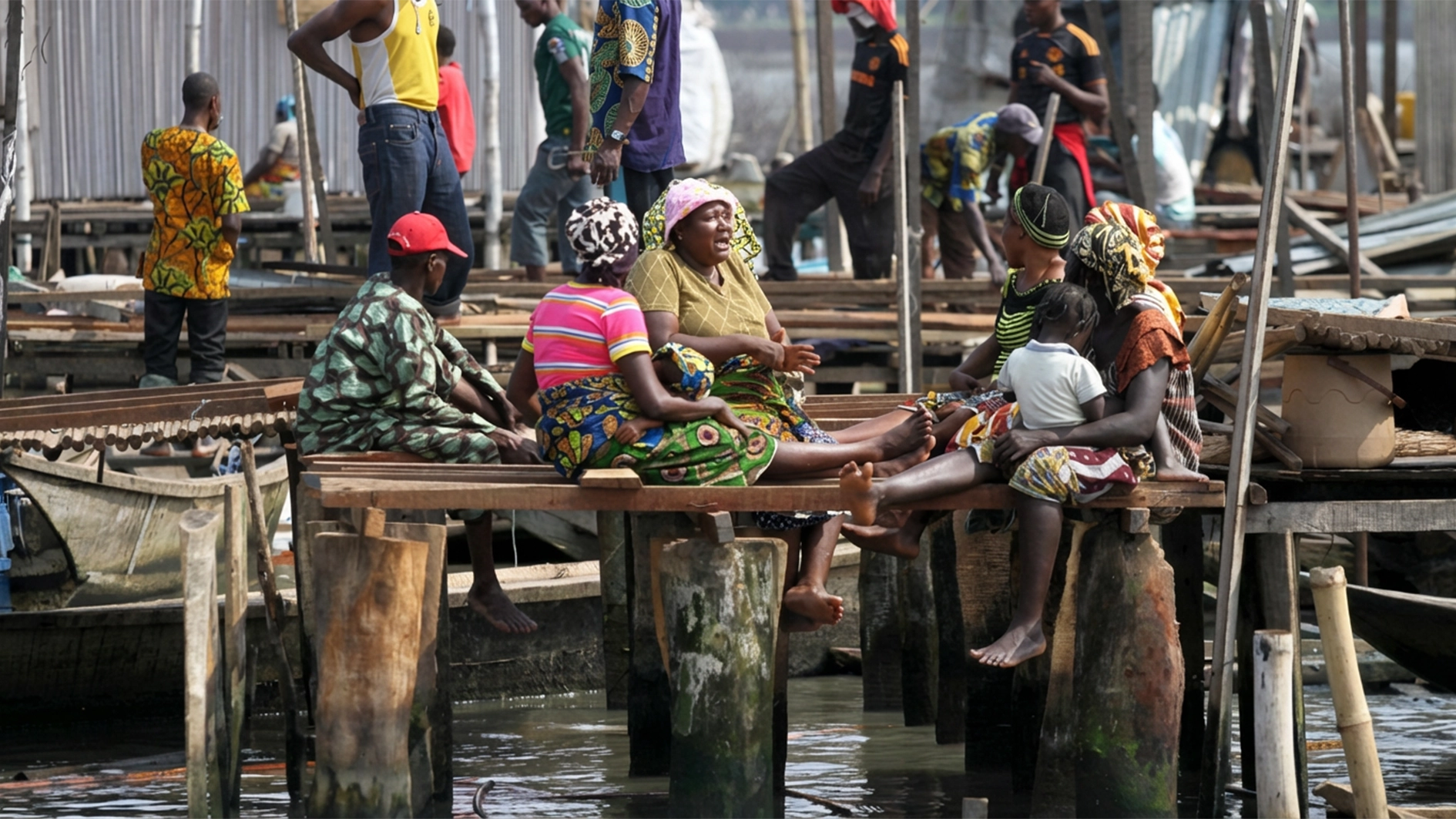 Residents sit outside their demolished stilt houses, after the metropolitan government begins the demolition of the Makoko riverine settlement on the Lagoon in Lagos