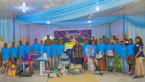 Group photo of beneficiaries, SROL Team, programme facilitor with vocational support equipment