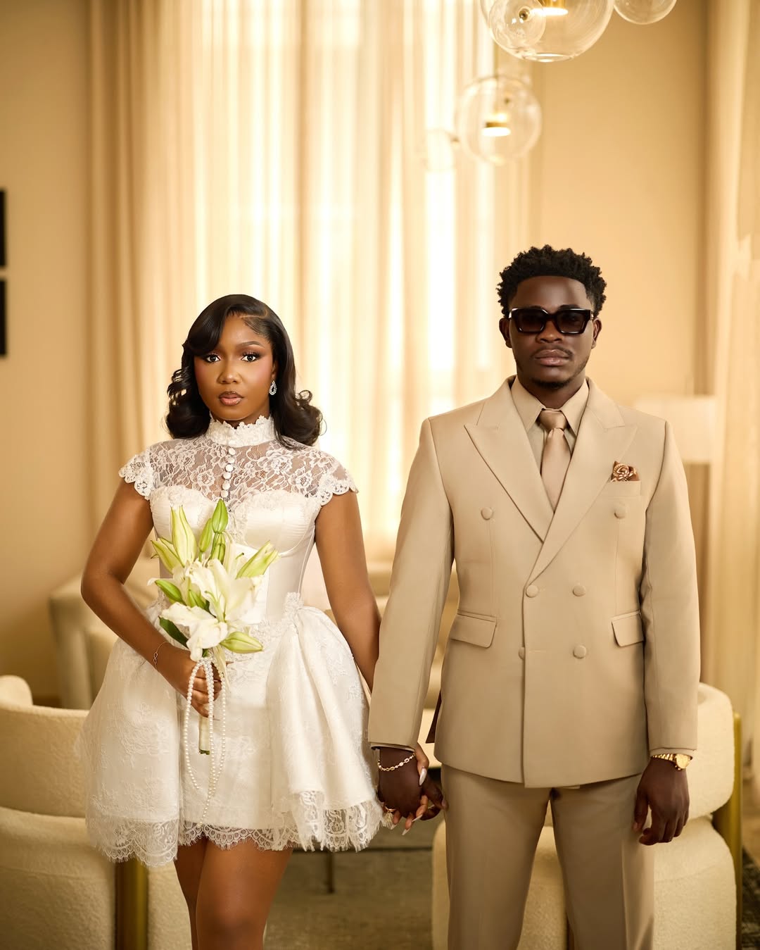 Simi Sanya holds Femi Dapson’s hand outside a Lagos courthouse after their civil wedding