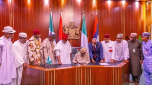 President Bola Ahmed Tinubu (middle) signing the Electoral Act (Amendment) Bill into law…recently.