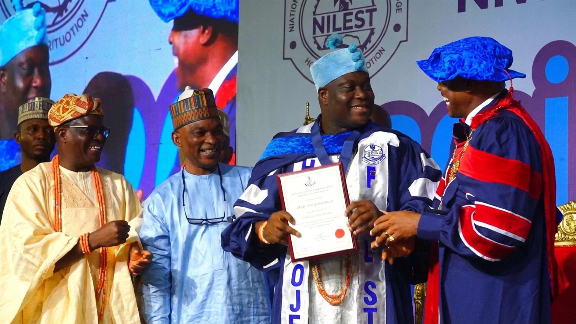 Fellow of the Nigerian Institution of Estate Surveyors and Valuers (NIESV) and Olu of Ilaro, Paramount Ruler of Yewaland, Alayeluwa Oba Kehinde Olugbenle (left); First Vice President, Bature Muhammad;  Ooni of Ife, Oba Adeyeye Enitan Ogunwusi, Ojaja II receiving an honorary fellowship of the institution from the NIESV President, Mr Victor Alonge at the 2026 induction ceremony in Abuja.