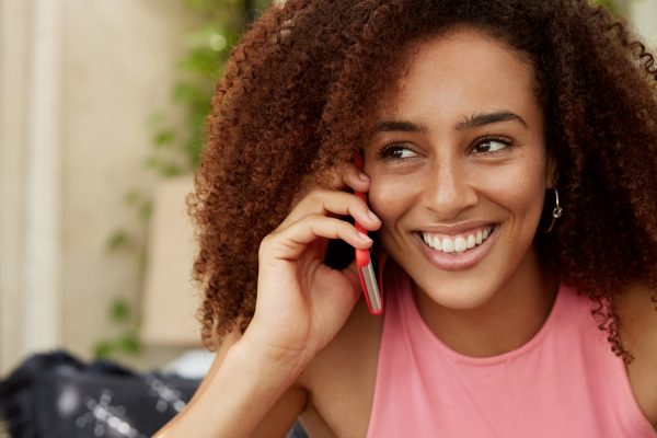 long-distance-valentines-day-couple-phone-call-woman-smiling.jpg