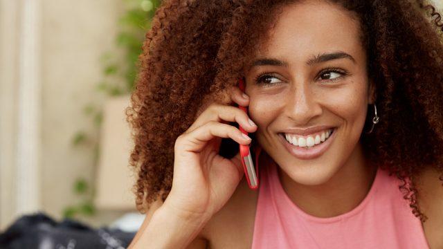 long-distance-valentines-day-couple-phone-call-woman-smiling.jpg