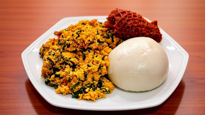 nigerian-breakfast-semolina-egusi-soup-assorted-meat.webp