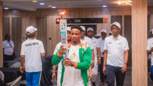 Joseph Edidiong, arriving with the torch at the Abia State Government House, Umuahia, yesterday.