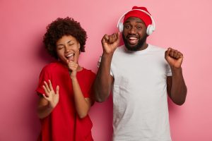 valentines-day-couple-dancing-music-headphones-pink-background.jpg