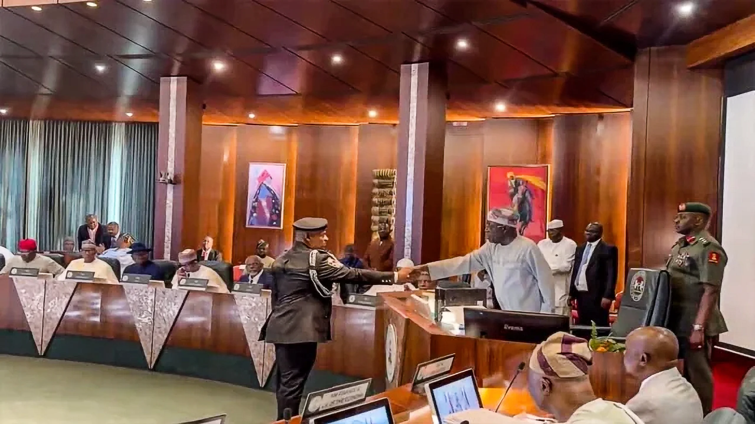 Prsident Tinubu (R) congratulates IGP Tunji Disu (L)