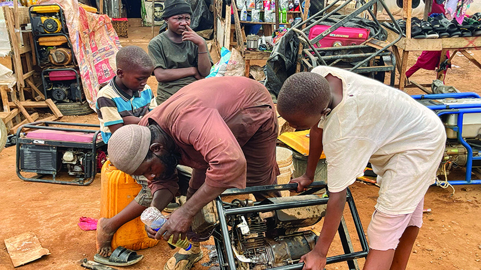 Assisted by his apprentices, a technician tries to fix a faulty power generating sets along EFAB junction, Lokogoma, Abuja. As extreme heat worsens, generators like this provide succour for households in the absence of stable electricity. 							         PHOTO: KINGSLEY JEREMIAH