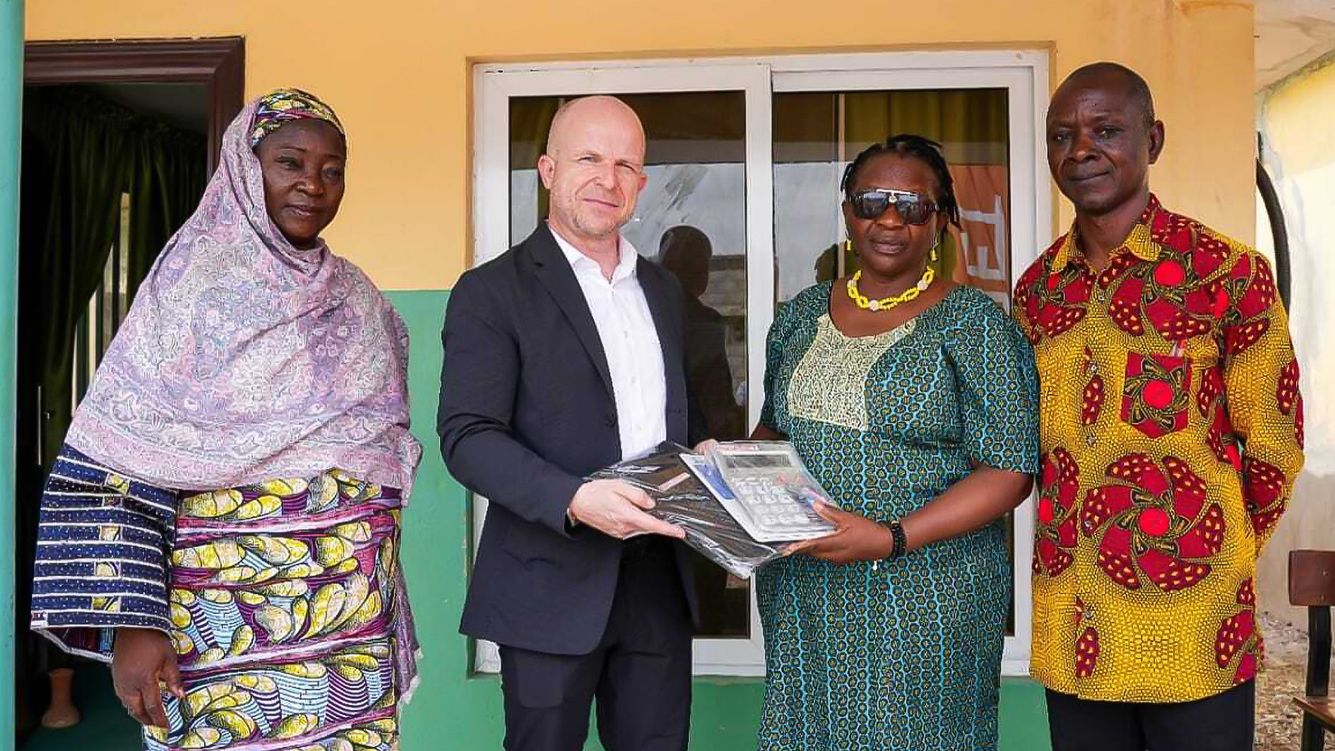 Head, FCT School of the Blind Jabi, Hajia Hamza (left); General Manager, ABUMET, Diemo Schillack (2nd left) presenting educational materials to the Head of Administration,  Jabi, Mrs Elizabeth Madaki and the General Duties Assistant of the school, Jonathan Momoh (right) during the CSR outreach on Friday.