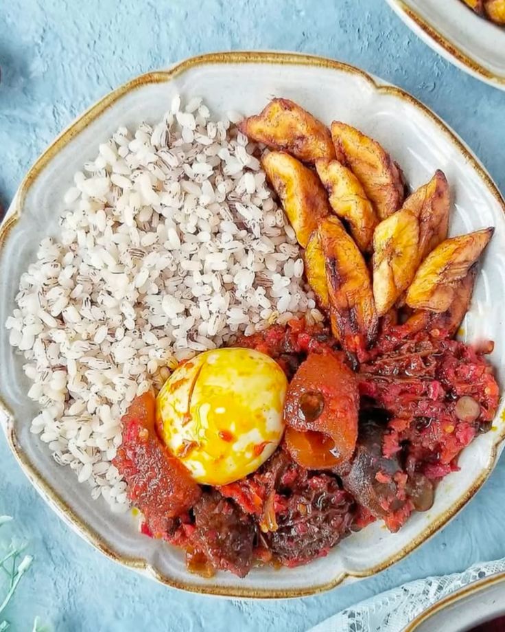 Local Ofada rice meal with assorted meat sauce