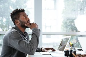man-thinking-laptop-office-decision-making.jpg