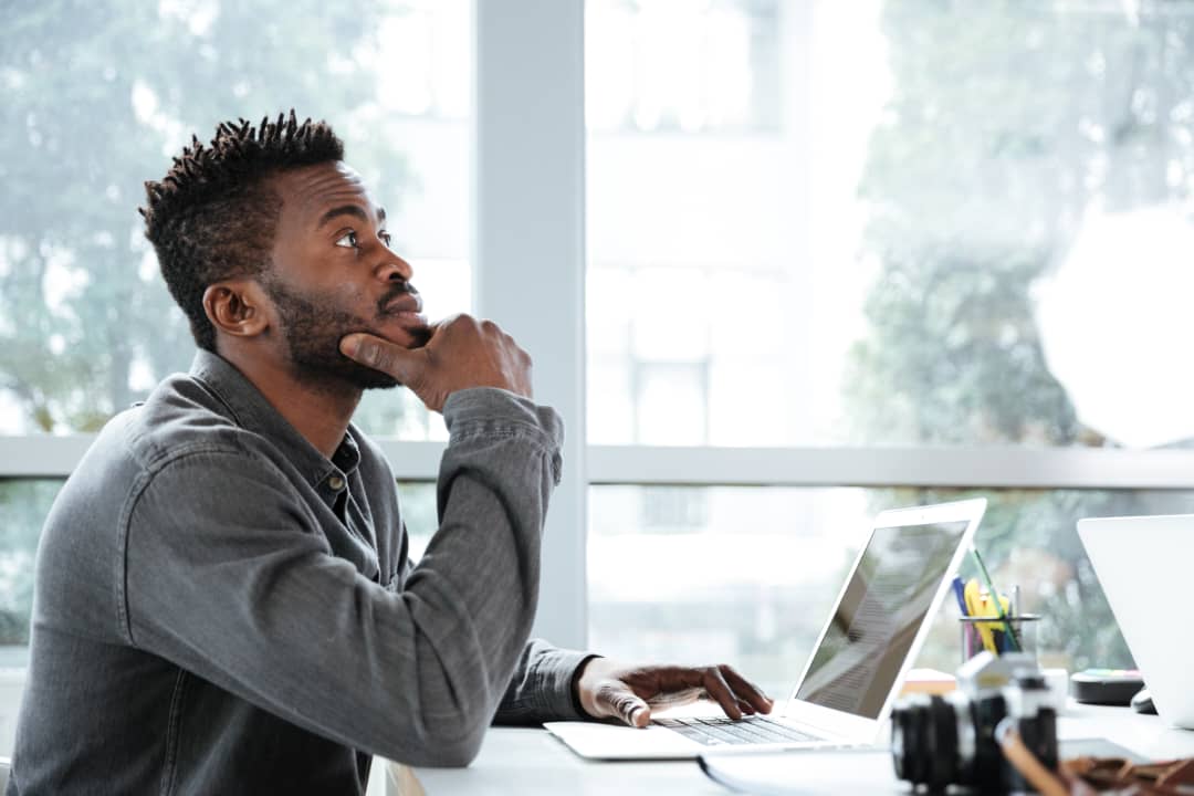 man-thinking-laptop-office-decision-making.jpg