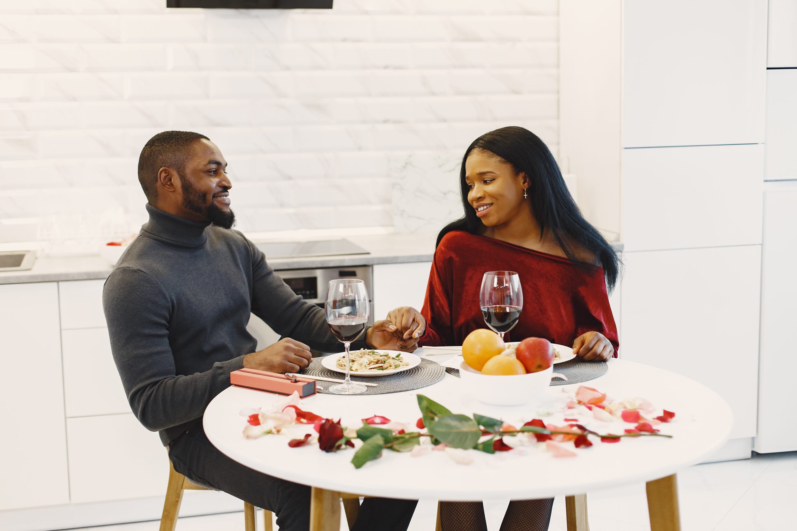 Valentines day. Couple sitting at table, having meal, talking and laughing. Beautiful couple celebrating.