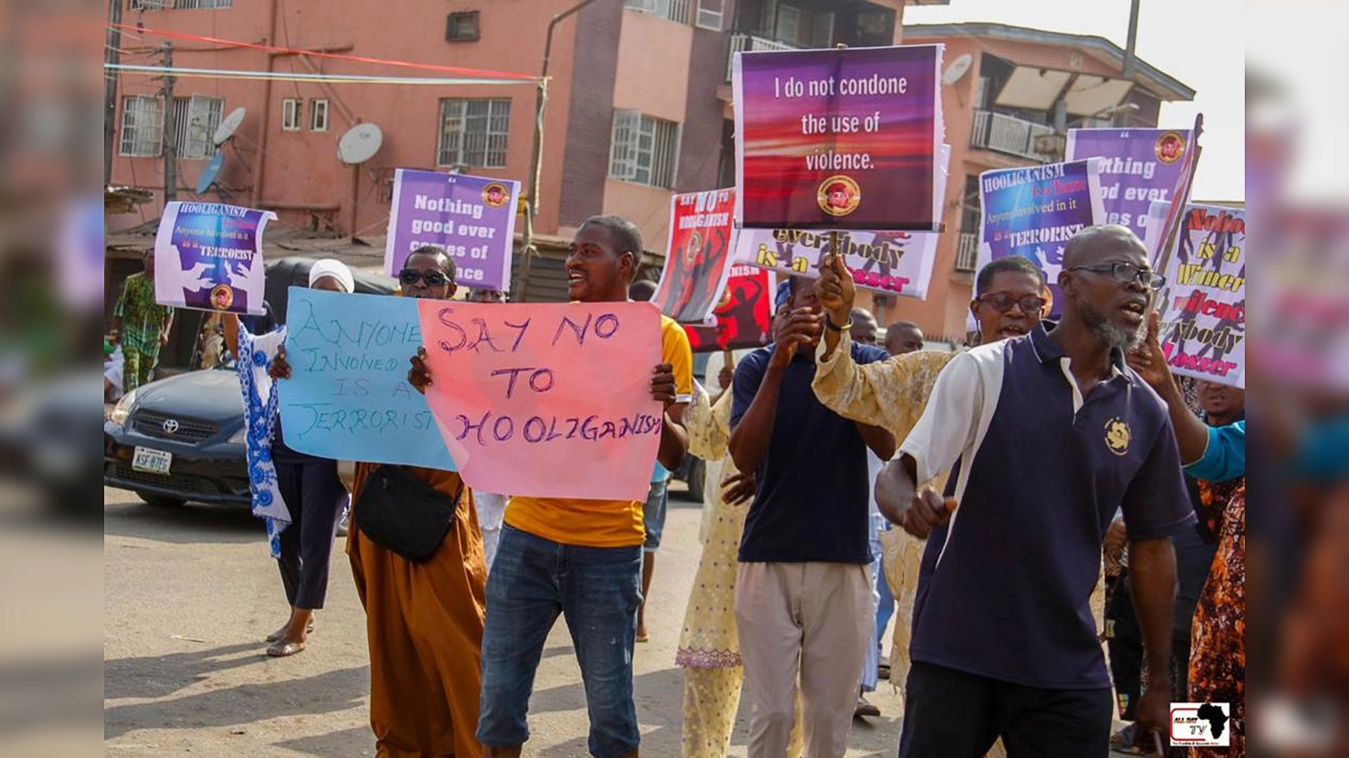 Protesting community members with damaged tricycle.
