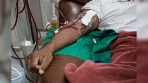 A kidney patient receiving treatment on a dialysis machine.