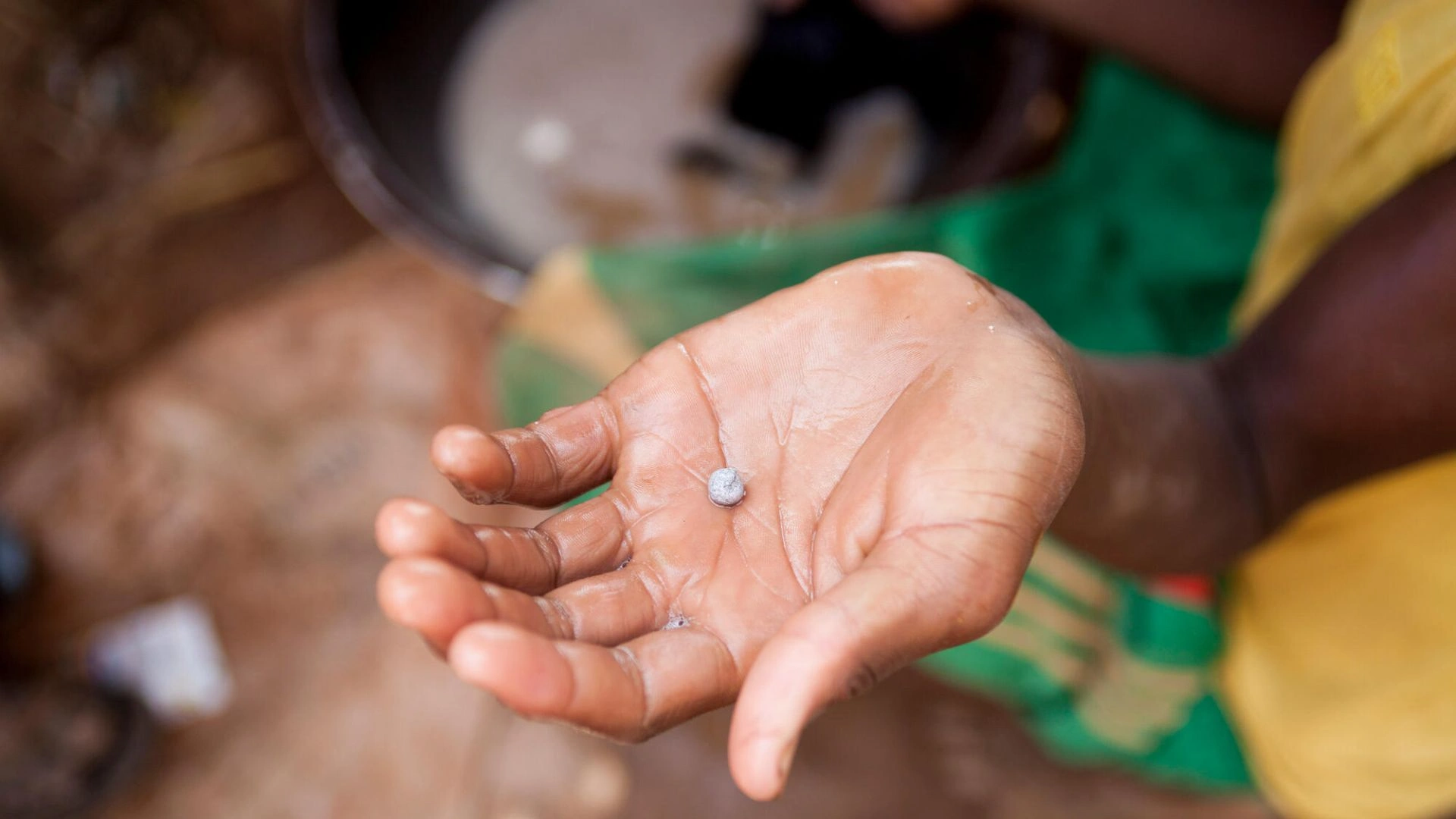 A worker shows the mercury-gold amalgam at the Bagega gold processing site. in northern Nigeria.