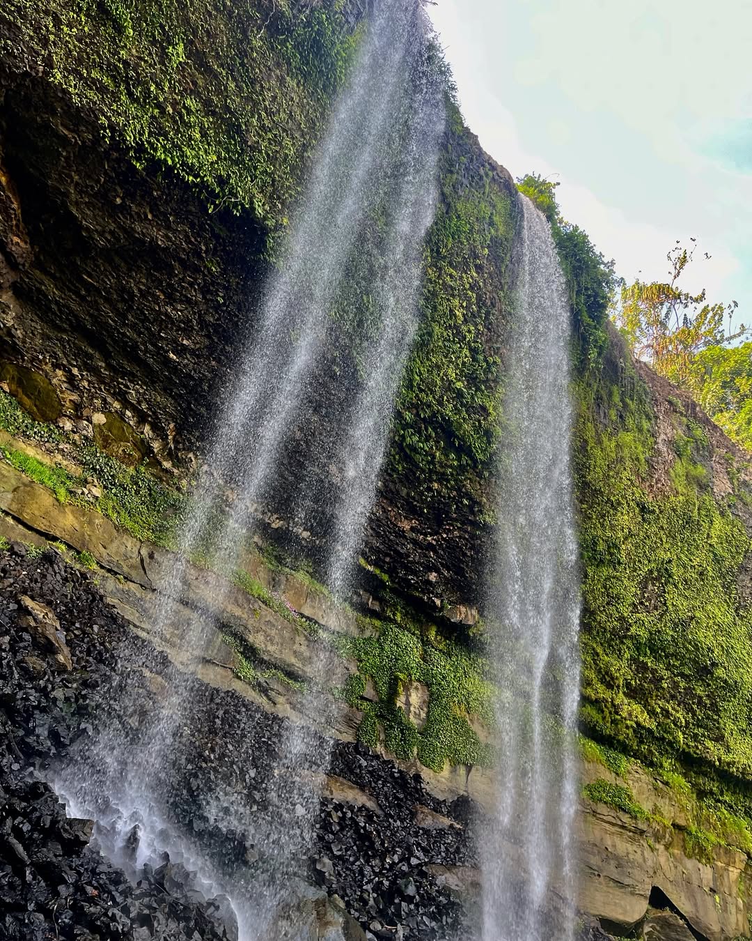 Agbokim Waterfalls flowing through tropical forest in Cross River Nigeria